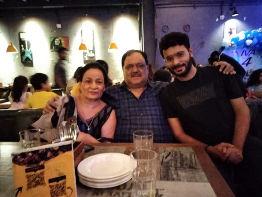 Sambhav with his parents.
